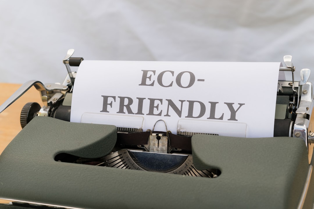 a close up of a typewriter with a paper that reads eco - friendly